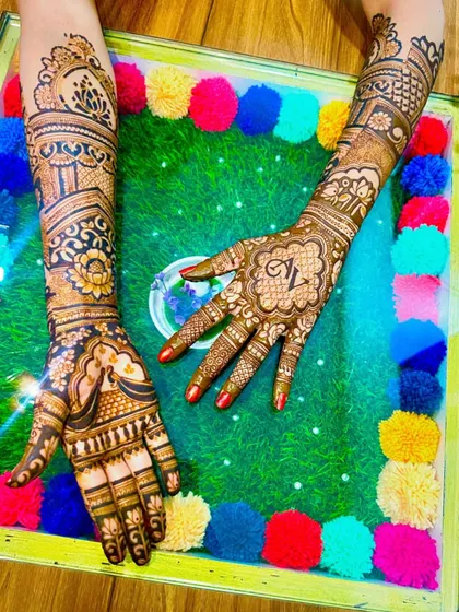 A design featuring the couple's initials 'AL' in a mandala, surrounded by traditional patterns.