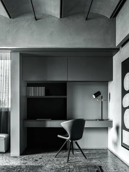 The master study in the Vaulted Haus is a compact, functional space hidden behind large sliding panels. The built-in desk and shelving are rendered in a monochrome palette, consistent with the apartment's overall aesthetic.