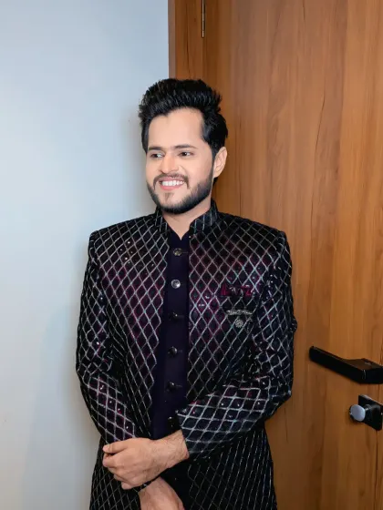 A candid, happy moment. This groom's look is perfect for a party, combining a fashionable jacket with a confident smile.