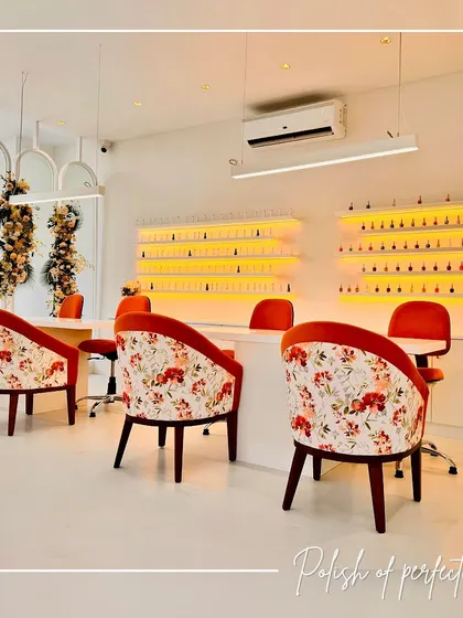 The nail art corner is where creativity blooms. I designed this area with custom floral-backed chairs and a well-lit display of nail polishes, turning the color selection into part of the experience. The bright, clean setup is both functional for the artists and inspiring for the clients.
