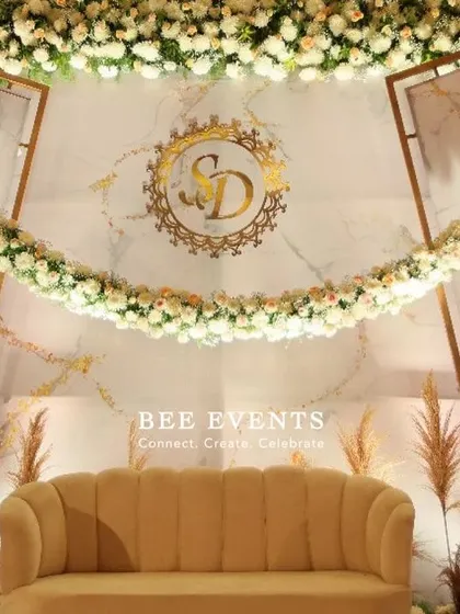 A detailed close-up of the personalized monogram and floral garland on our marble-effect reception backdrop. We believe these custom touches make your special day truly yours.