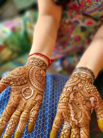 A more detailed design for a close family member of the bride. The palms are filled with traditional Indian patterns, including a hidden name 'Abhinav'.