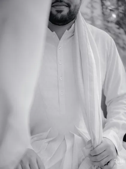 The quiet calm before the baraat. This black and white portrait of the groom, Manan, captures a moment of introspection and anticipation.
