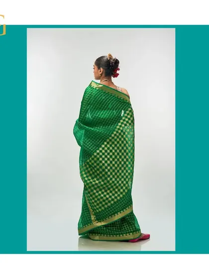 The back of the shamrock green saree, showing how the gold zari checks create a stunning visual effect.