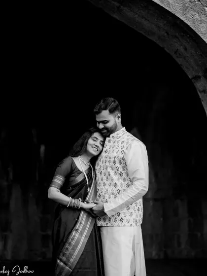 A classic black and white portrait. The deep shadows and soft light create a timeless and emotional image of Ankush and Aishwarya during their pre-wedding session.