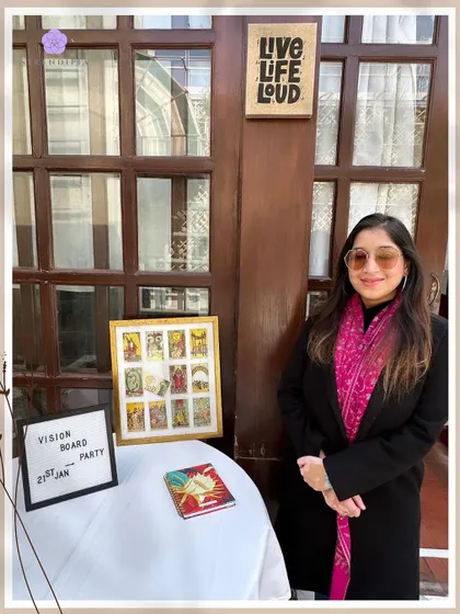 Posing proudly at the entrance to another successful Vision Board Party. I love creating a welcoming space where people can connect and get clear on their goals for the year ahead. Let's turn dreams into reality together.