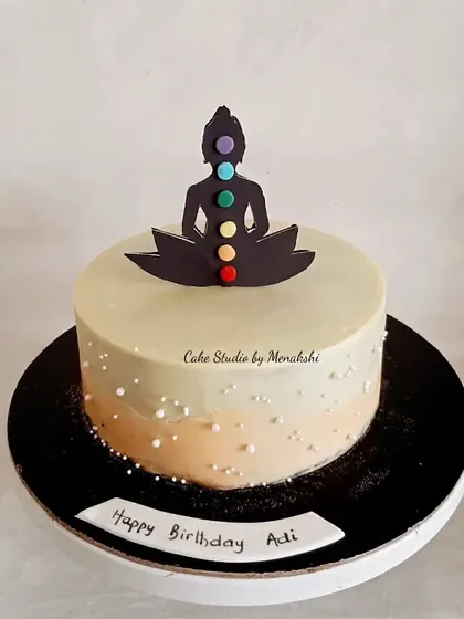 For someone who loves meditation. This simple and serene cake features a silhouette of a person meditating with the seven chakras.