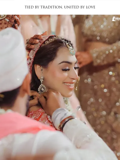 A beautiful moment from the wedding ceremony where the groom, Shashank, lovingly touches the bride Hashmeeta's chin.