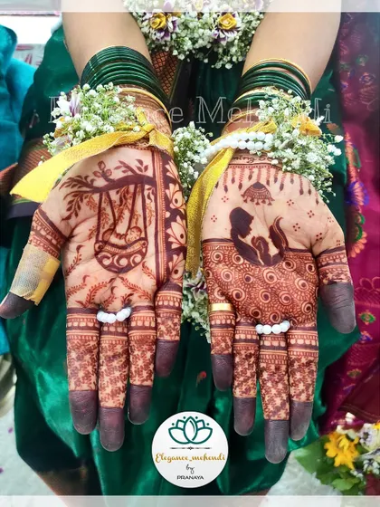 The beautiful, dark stain of a baby shower mehendi. This design features a mother cradling her baby and a traditional cradle, symbolizing the love and anticipation for the new arrival.