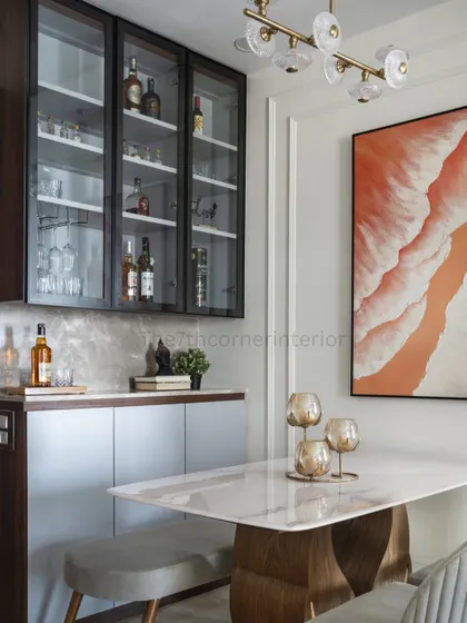 A closer look at the custom bar unit, featuring profile shutters with clear glass and integrated lighting. The Italian marble countertop and cladded backsplash exude luxury and style.