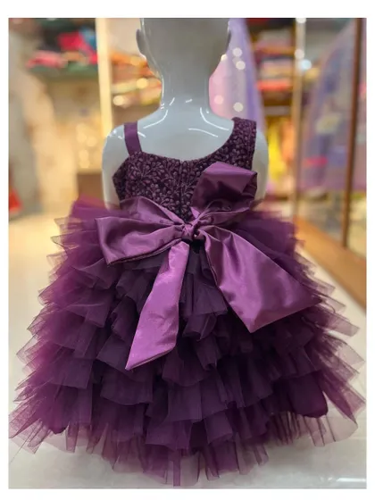 The back of the purple frills gown features a large satin bow.