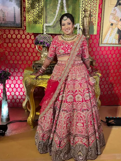 A full-length shot of the bride in her beautiful red lehenga, looking absolutely radiant.
