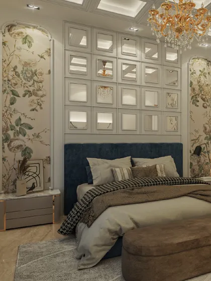 Luxury meets tranquility in this elegant bedroom. We used soft floral wallpaper to bring a timeless charm, while the statement mirrored wall above the plush blue headboard adds depth and a touch of modern glamour.