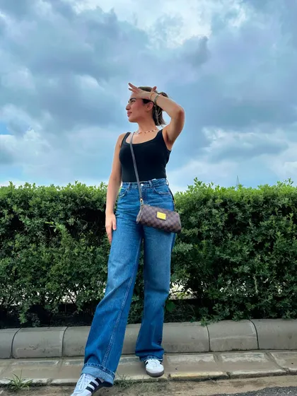 Looking up at the sky, feeling the breeze. This outfit is perfect for a relaxed day outdoors.