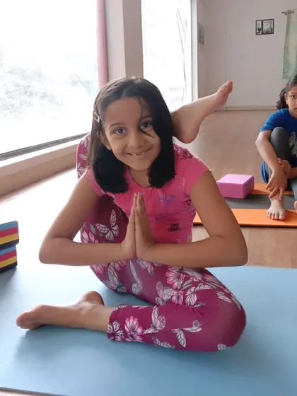 Look at that smile. This young yogi is mastering Eka Pada Sirsasana, or the leg-behind-head pose, with confidence. My goal is to help every child feel proud of their progress, no matter the pose.