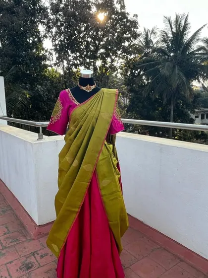 A half saree with a pink blouse and a light green silk dupatta.