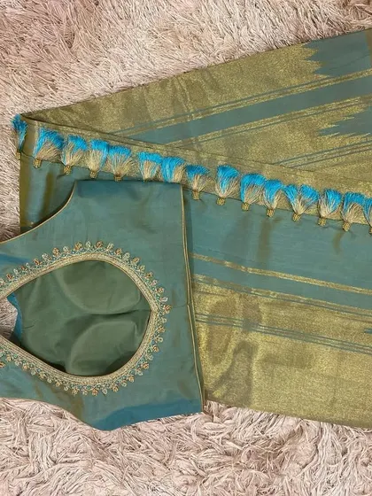 A beautiful teal and gold silk saree paired with a custom embroidered teal blouse.
