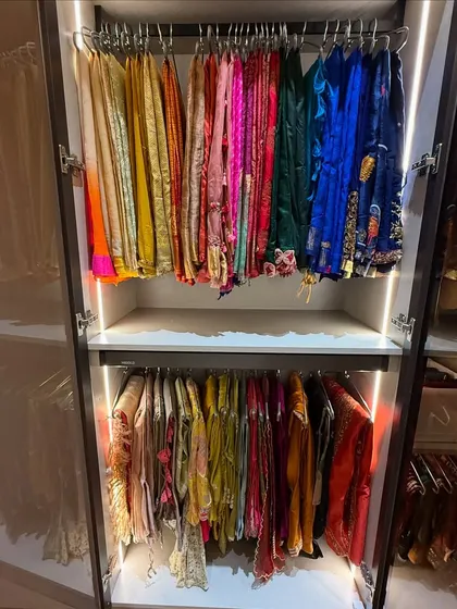 A rainbow of color in this festive wear closet. We organize by color and occasion, hanging delicate items to maintain their shape and beauty. The integrated lighting makes selecting the perfect outfit a delight.