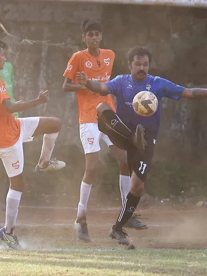 A player executes a powerful volley during the MFA league game. The action is fast-paced and requires a high level of technical skill.