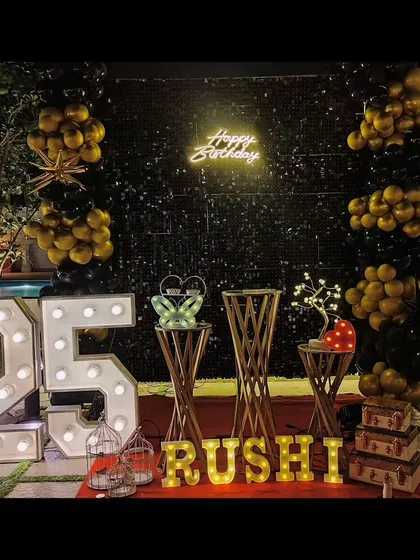 An elegant outdoor 25th birthday celebration by the pool. We used a black sequin wall, gold and black balloons, and marquee lights to create a sophisticated and memorable party atmosphere at night.