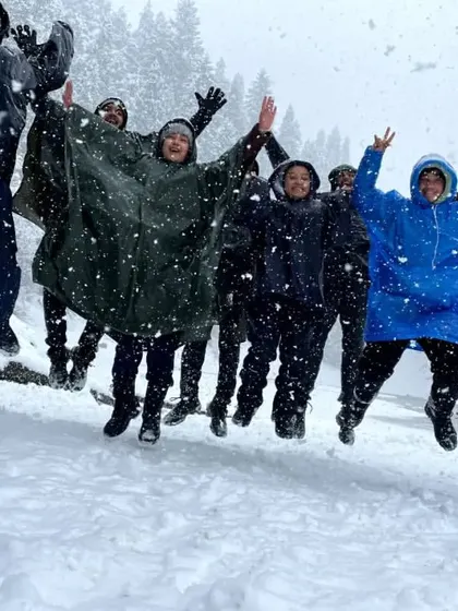 The whole group jumping for joy in the snow. The energy and excitement of a winter trek are contagious, and we love sharing these happy moments with our Musafir family.