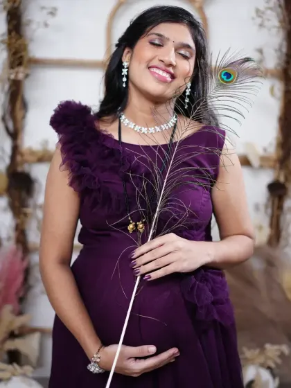 A happy client during her maternity photoshoot in my popular wine-colored ruffle gown. I can also help arrange makeup services for your shoot when you rent an outfit from my store.