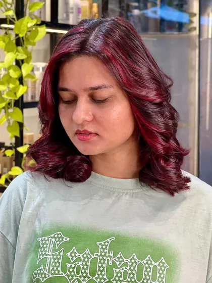 How pretty is this red? A beautiful shade that is both vibrant and rich, styled with soft waves to show off the dimension.