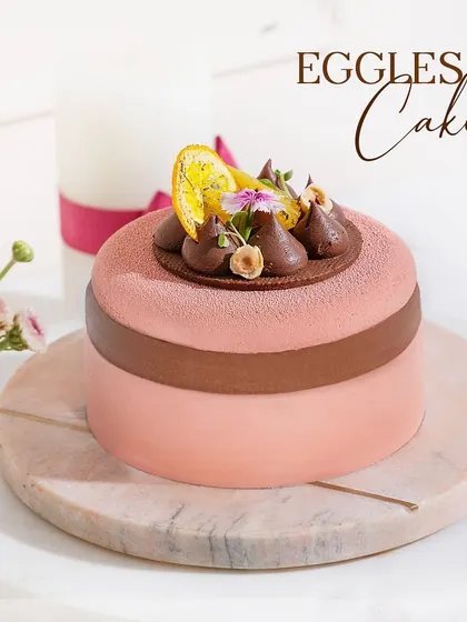 An eggless cake that compromises on nothing. This beautiful pink and brown entremet is a testament to our commitment to delicious desserts for everyone.
