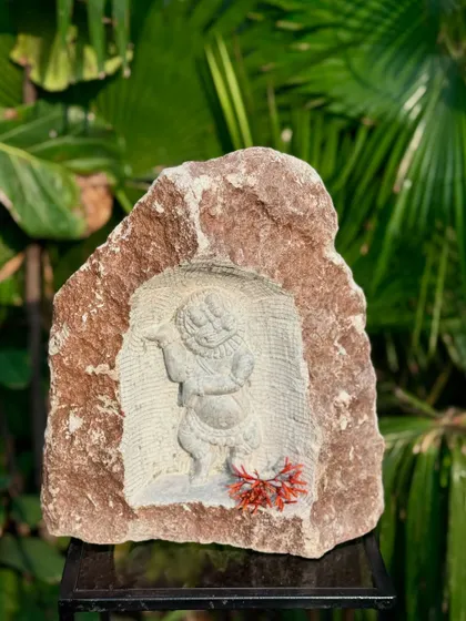 A niche carving of Bala Krishna, sculpted into a natural rock. Inspired by South Indian temple art, these pieces bring a sense of history and spirituality to your outdoor or indoor decor.