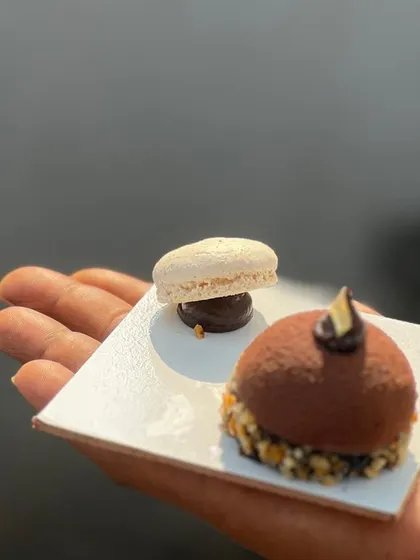 My "Monalisa" dessert, a chocolate dome filled with an almond praline crunch. It's served with a delicate macaron for a multi-textured dessert experience.
