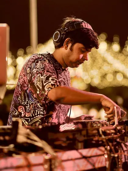 Focused on the mix. A clear shot of me at the console during a night event, ensuring every transition is perfect to maintain the party's momentum.