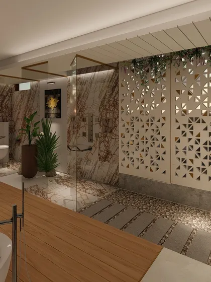 A view of the open-layout bathroom, showing the walk-in shower with a glass partition and a decorative screen that adds privacy and a geometric pattern. The floor combines wood, pebbles, and stone for a tactile experience.