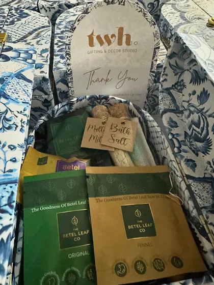 Inside our blue and white floral "Thank You" boxes. We included unique local products like The Betel Leaf Co. tea, making it a memorable and distinctly Indian gift.
