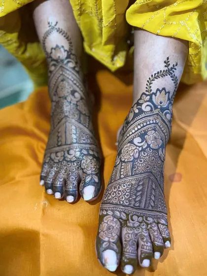 An intricate design for the bride's feet, featuring a combination of floral and geometric patterns that extend from the ankle to the toes.