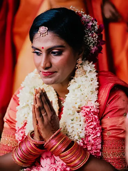 A close-up capturing the devotion and beauty of the bride during the ceremony. The makeup is designed to be resilient through emotional and lengthy rituals.