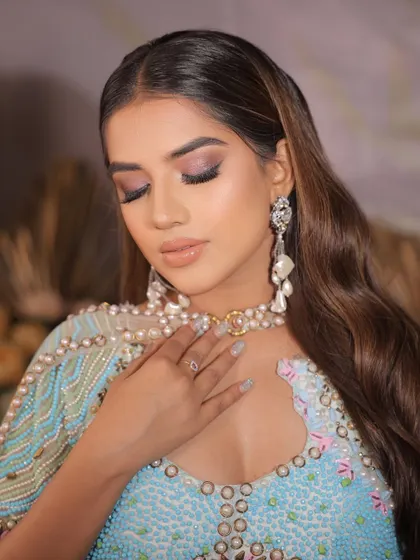 A close-up of a glamorous cocktail look, featuring a smokey eye with a hint of shimmer and glossy lips.