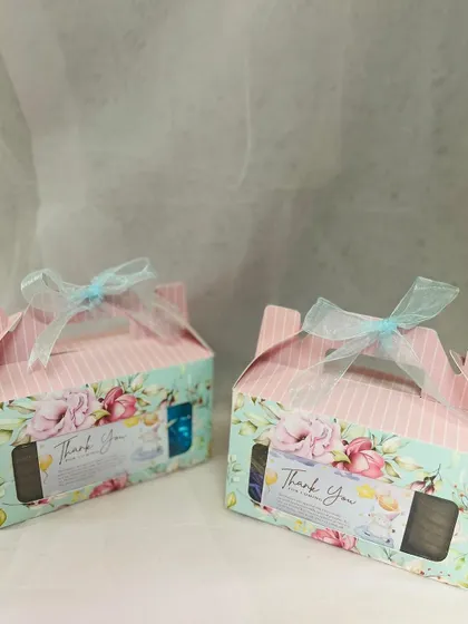 These baby shower return gift hampers are perfect for showing appreciation to your guests. The floral design and light blue ribbon give them a delicate and elegant feel.