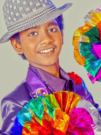 A professional portrait from my younger years. I've always loved the vibrant and visual aspect of magic, using colorful props to create eye-catching illusions.