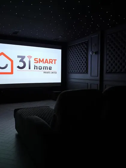A low-light shot showing the theater ready for a movie. The dark colors and minimal reflections ensure a completely immersive experience.