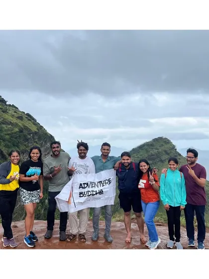 Another successful summit. Our group proudly holds the Adventure Buddha banner on a peak in Chikmagalur, celebrating the shared effort and the incredible views.