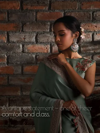 Crafting opulence, one drape at a time. This sage green organza saree is a symbol of timeless heritage infused with expressive modernity.