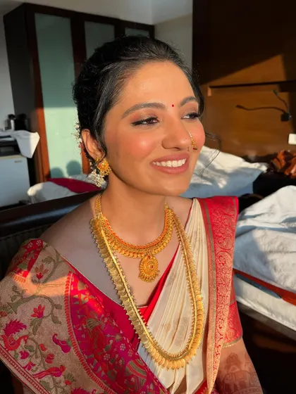 The bride's happy expression shows her delight with the final look. The minimal makeup and traditional styling created a look that was uniquely her.