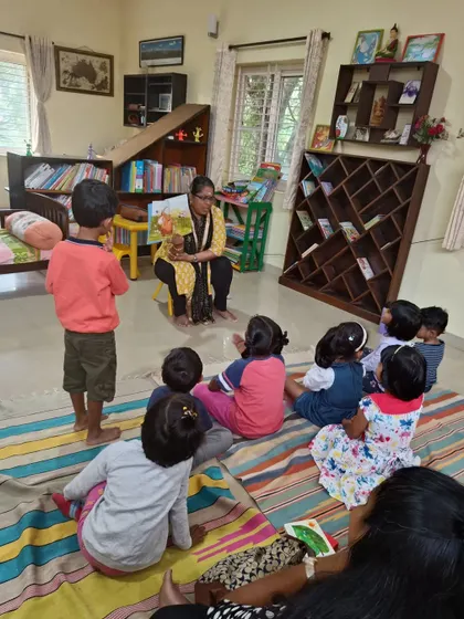 A child stands up to get a better look, showing his enthusiasm and engagement with the story.