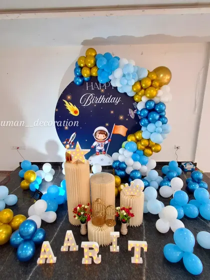 A complete view of the space party decor on a raised platform, ready for celebration.