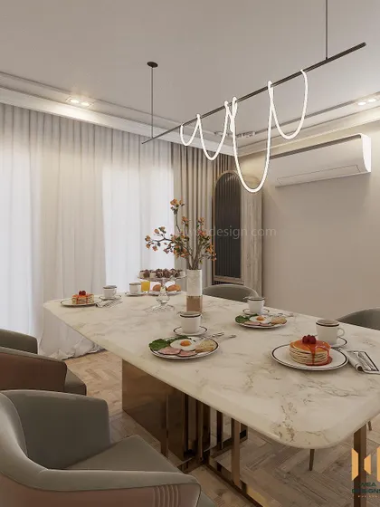 The dining table is set for a meal, showcasing how the space combines everyday function with high-end design, featuring a marble top and modern lighting.