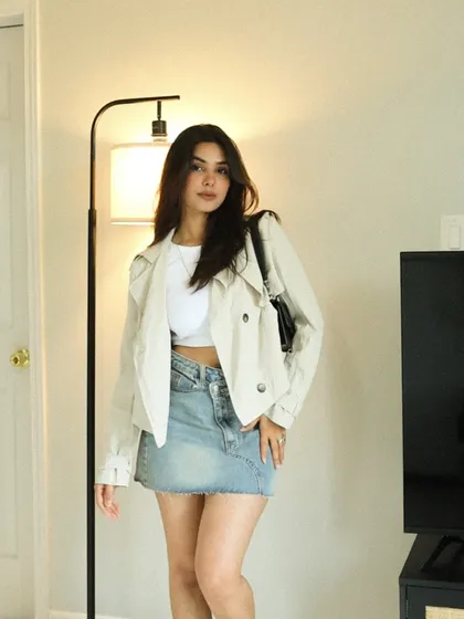 A cute and casual outfit with a cropped trench jacket and a denim mini-skirt.