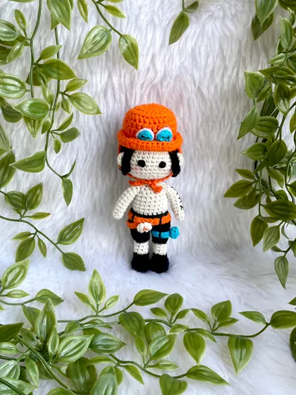 Ace from One Piece! I love creating anime characters because they are so unique and let me be creative. This doll features his signature hat, tattoos, and accessories.