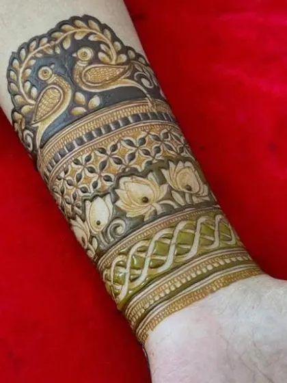 Another view of the stunning bird and lotus armband, showcasing the dark, rich stain of our organic henna.