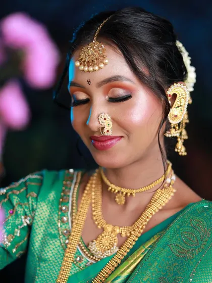 A close-up of the Maharashtrian bridal look taught in our new batch. The eye makeup features a beautiful blend of orange and gold, paired with a traditional nath and bindi.