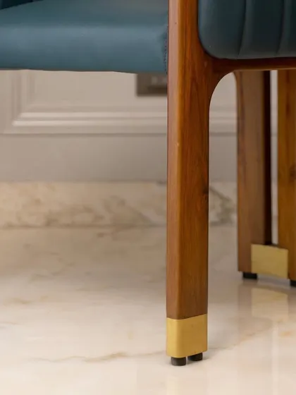 The legs of this accent chair feature custom brass caps, a small detail that adds a significant touch of luxury. It's this attention to the finer points that defines my work.
